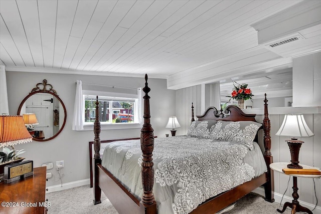 carpeted bedroom featuring ornamental molding and wooden ceiling