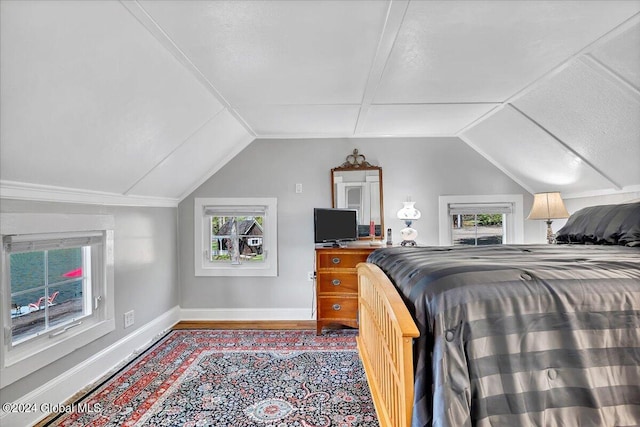 bedroom with wood-type flooring and lofted ceiling