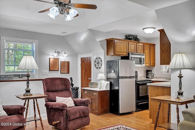 kitchen with ceiling fan, appliances with stainless steel finishes, and light hardwood / wood-style floors