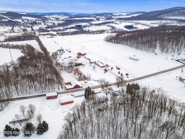 snowy aerial view with a mountain view