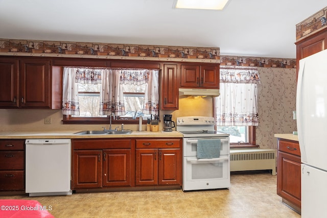 kitchen with white appliances, radiator heating unit, light countertops, under cabinet range hood, and a sink