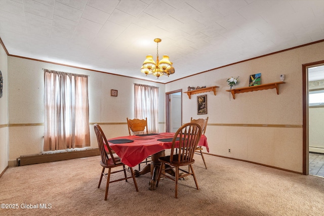 dining area with baseboards, a baseboard radiator, an inviting chandelier, carpet, and crown molding