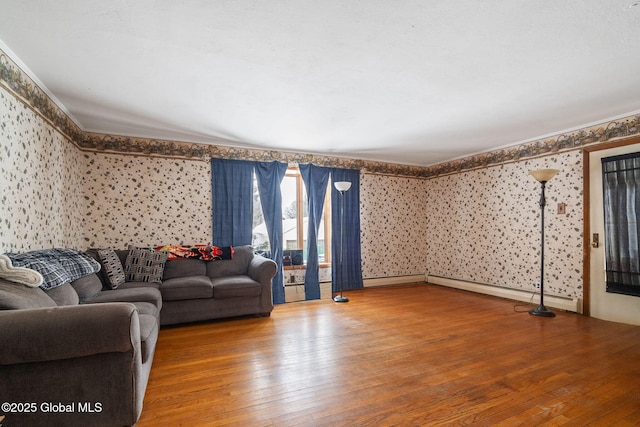 living area with ornamental molding, hardwood / wood-style floors, and wallpapered walls