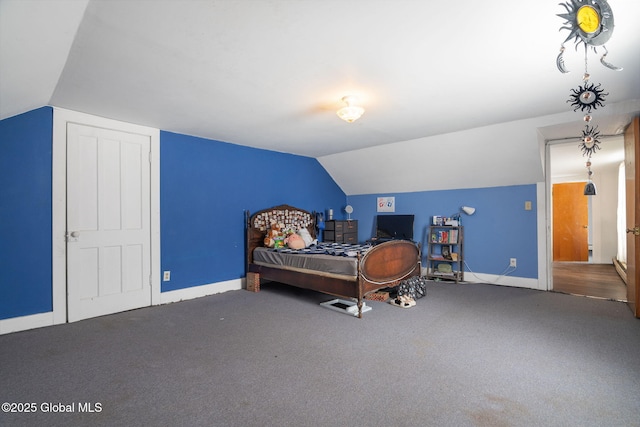 bedroom with vaulted ceiling, carpet, and baseboards