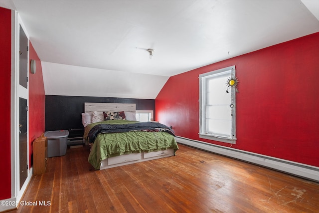 bedroom featuring a baseboard heating unit, lofted ceiling, and hardwood / wood-style flooring