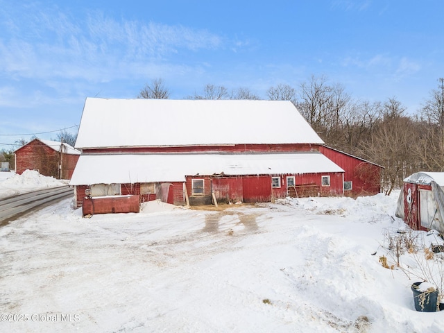 exterior space featuring a barn and an outbuilding