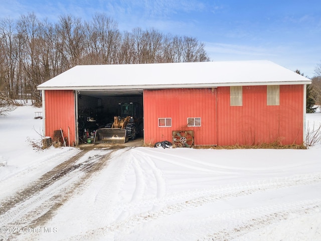 snow covered garage with a garage