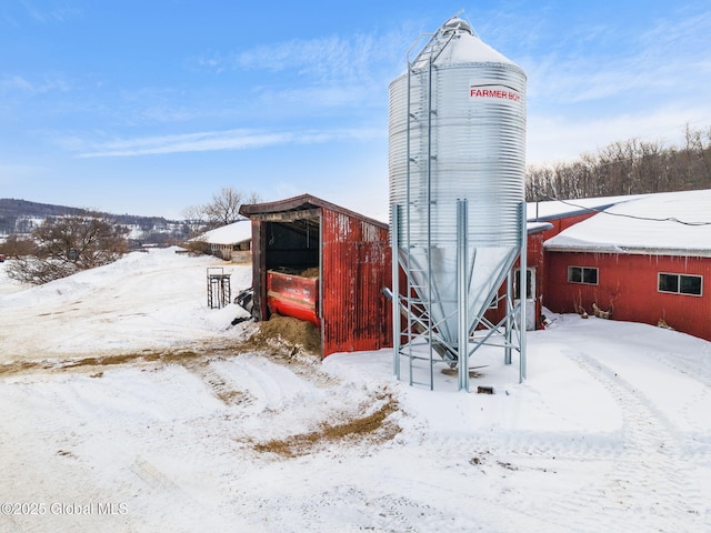 snow covered structure featuring an outdoor structure