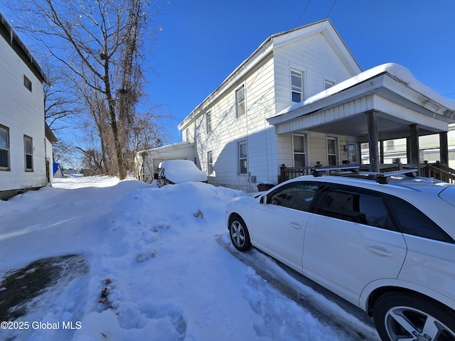 view of snow covered exterior with a porch