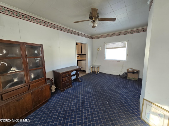 interior space with dark colored carpet and ceiling fan