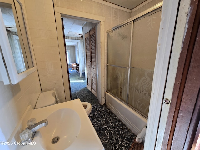 full bathroom with vanity, combined bath / shower with glass door, and toilet