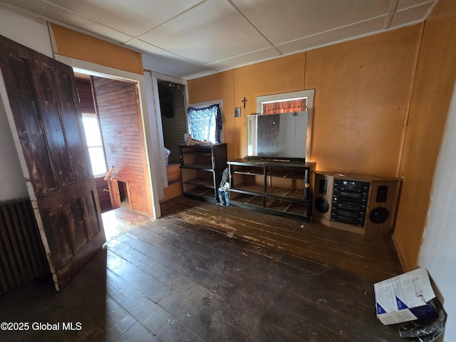 interior space featuring a mail area, radiator heating unit, and dark hardwood / wood-style floors