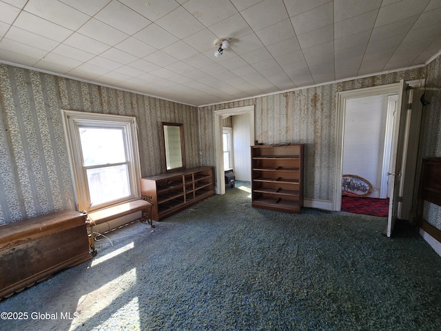 unfurnished bedroom with crown molding and carpet flooring