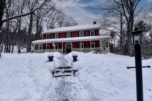 view of front facade with covered porch and brick siding