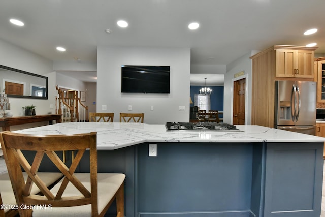 kitchen featuring a spacious island, a kitchen breakfast bar, stainless steel appliances, and recessed lighting