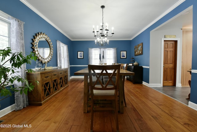 dining space with ornamental molding, baseboards, and hardwood / wood-style flooring