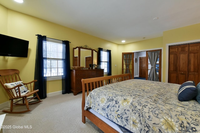 bedroom featuring light carpet, a closet, recessed lighting, and baseboards