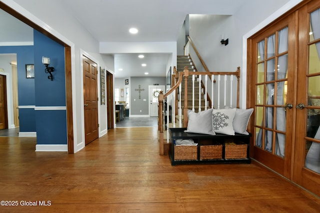 entrance foyer featuring recessed lighting, baseboards, stairs, french doors, and wood-type flooring