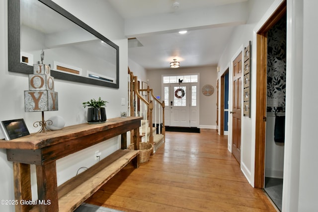 foyer entrance featuring light wood-type flooring and baseboards