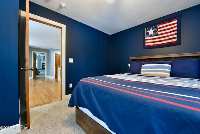 bedroom featuring carpet floors, a ceiling fan, and baseboards