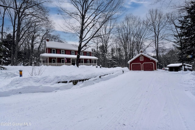 view of front facade featuring a detached garage and an outdoor structure