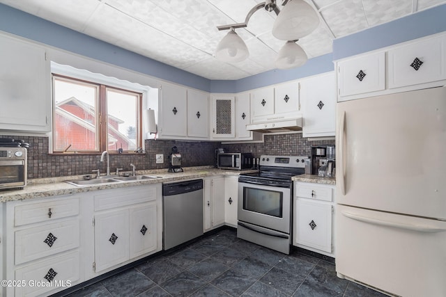 kitchen featuring sink, decorative backsplash, white cabinets, and appliances with stainless steel finishes