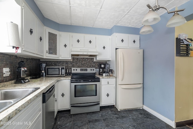 kitchen featuring white cabinetry, decorative backsplash, decorative light fixtures, and appliances with stainless steel finishes