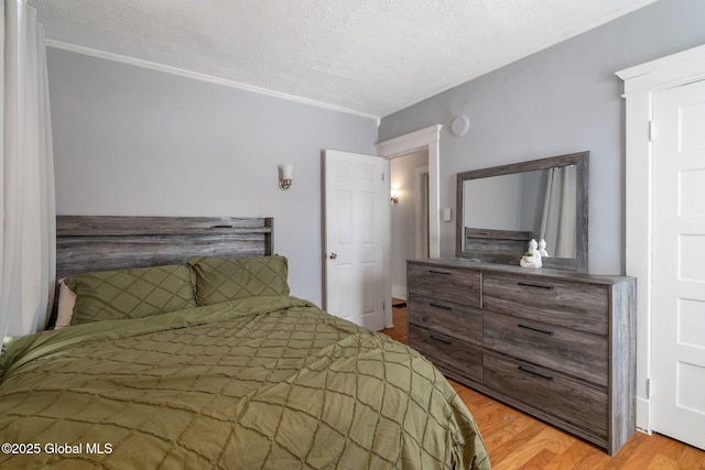 bedroom featuring a textured ceiling and light hardwood / wood-style floors