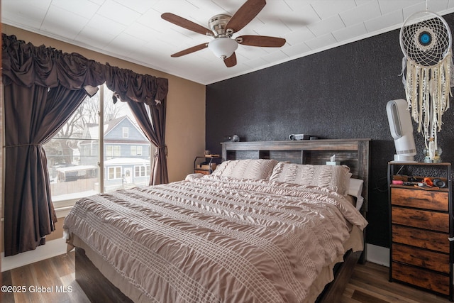 bedroom with ornamental molding, hardwood / wood-style floors, and ceiling fan