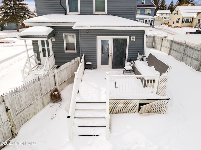 snow covered property featuring a wooden deck