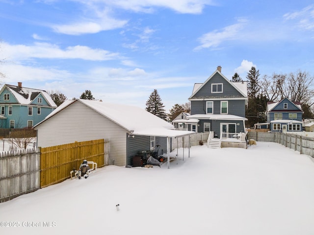 snow covered house with a porch