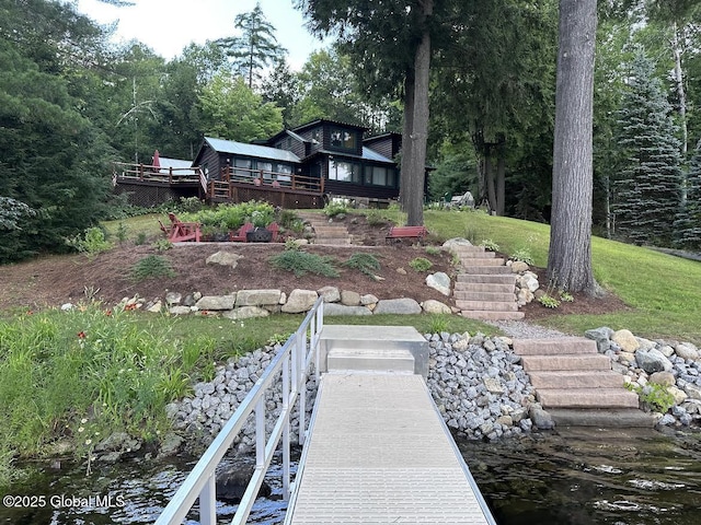 back of house featuring a deck with water view