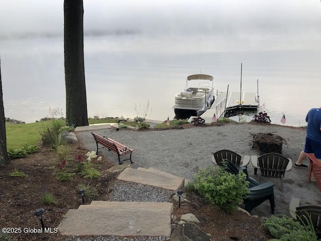 exterior space with a water view and a boat dock