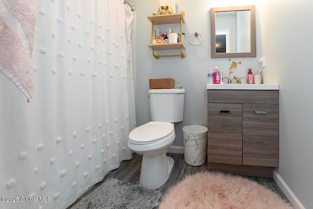 bathroom featuring vanity, hardwood / wood-style flooring, and toilet