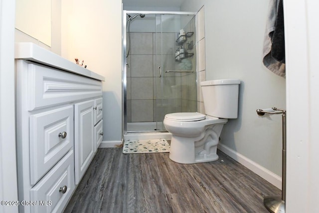 bathroom featuring wood-type flooring, toilet, and walk in shower