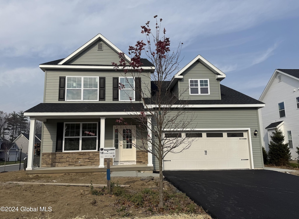 view of front of home with a garage and covered porch