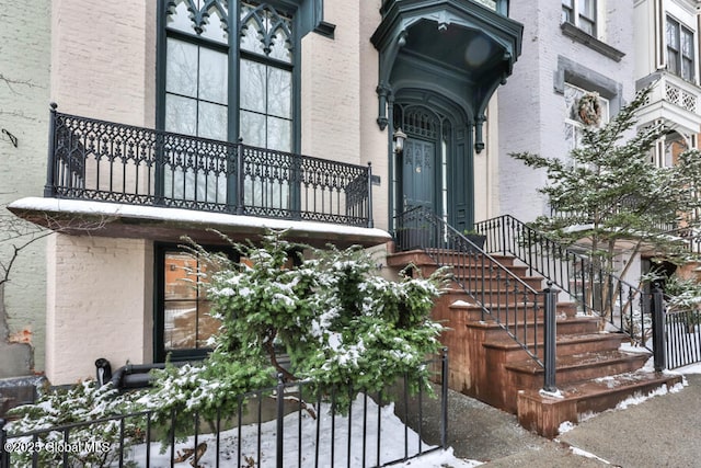 view of snow covered property entrance