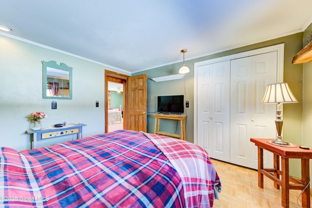 bedroom with crown molding, light parquet flooring, and a closet