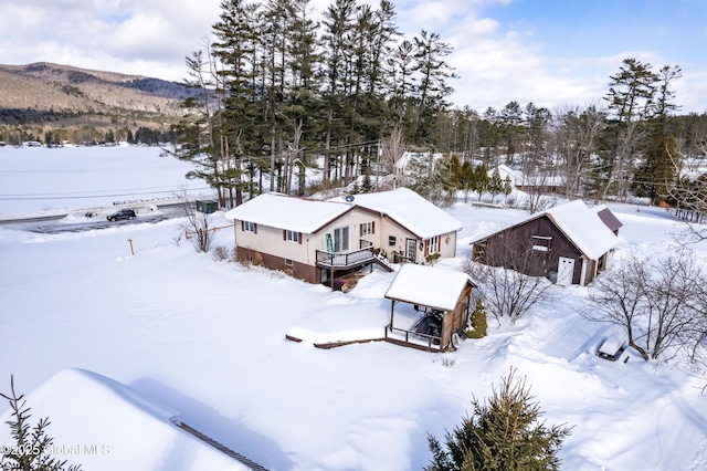 snowy aerial view featuring a mountain view