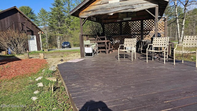 wooden terrace featuring a gazebo