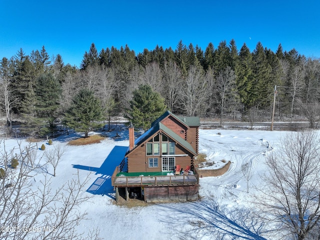 view of snow covered back of property