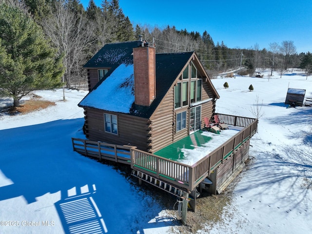 snow covered property featuring a wooden deck