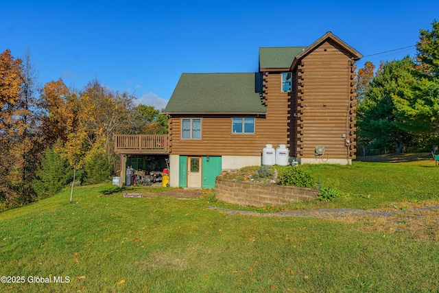 back of house featuring a wooden deck and a lawn