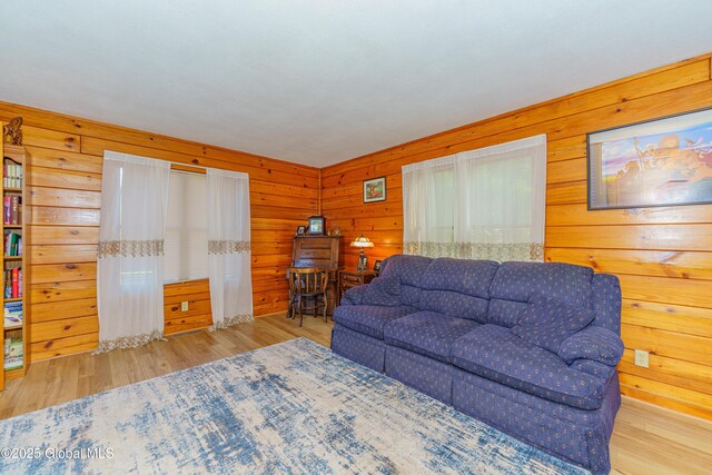 living room with wooden walls and light wood-type flooring