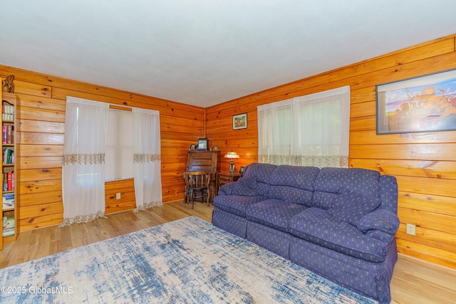 living room featuring wood walls and light wood-type flooring