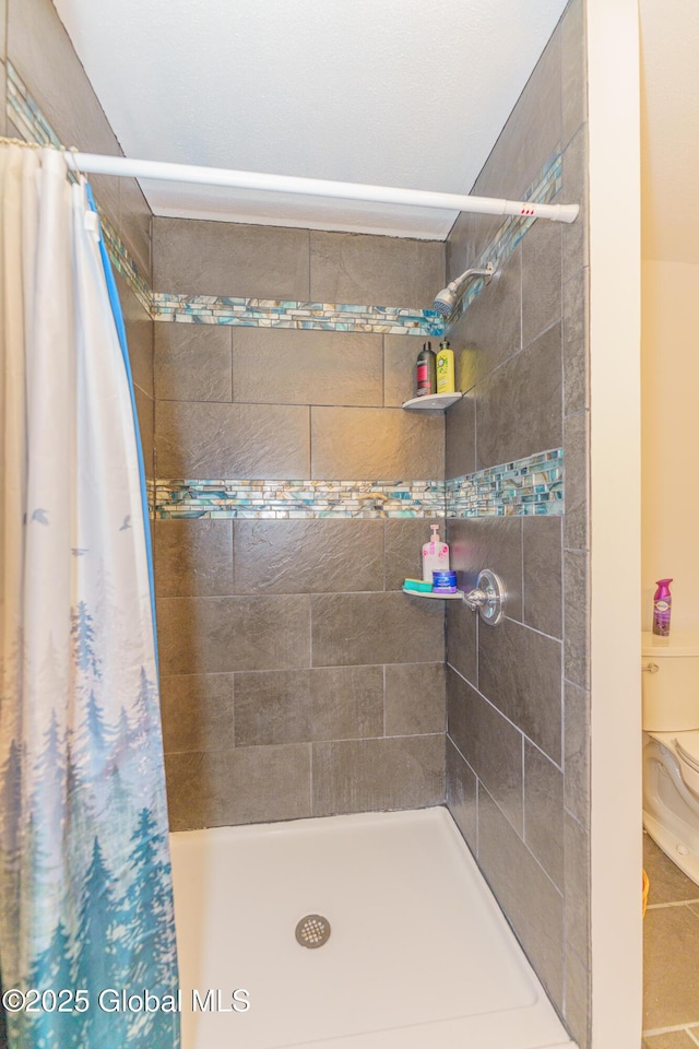 bathroom featuring toilet and walk in shower