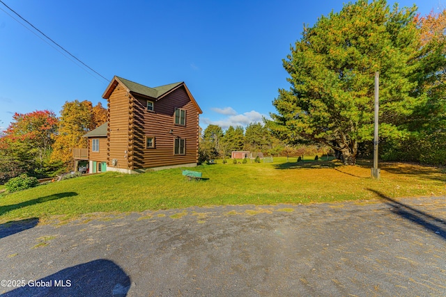 view of property exterior with a lawn