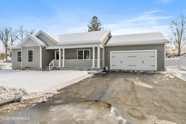 single story home featuring driveway, a garage, and fence