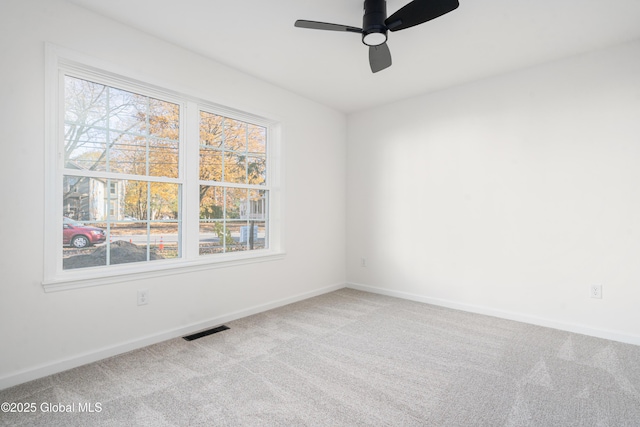 unfurnished room with plenty of natural light, carpet floors, and ceiling fan