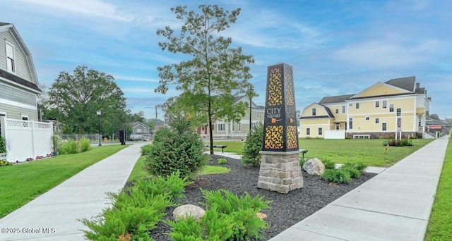 surrounding community with fence and a lawn